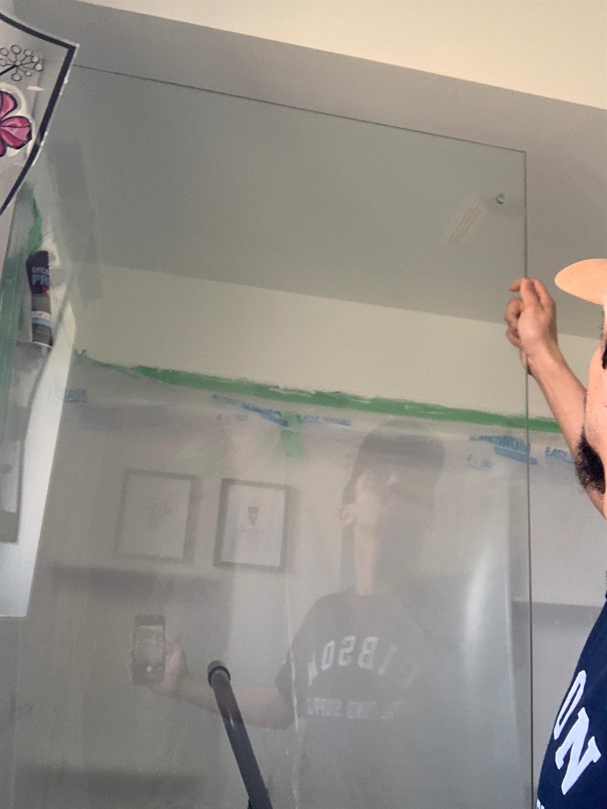 Meticulous wall painting using protective plastic containment to keep the home clean